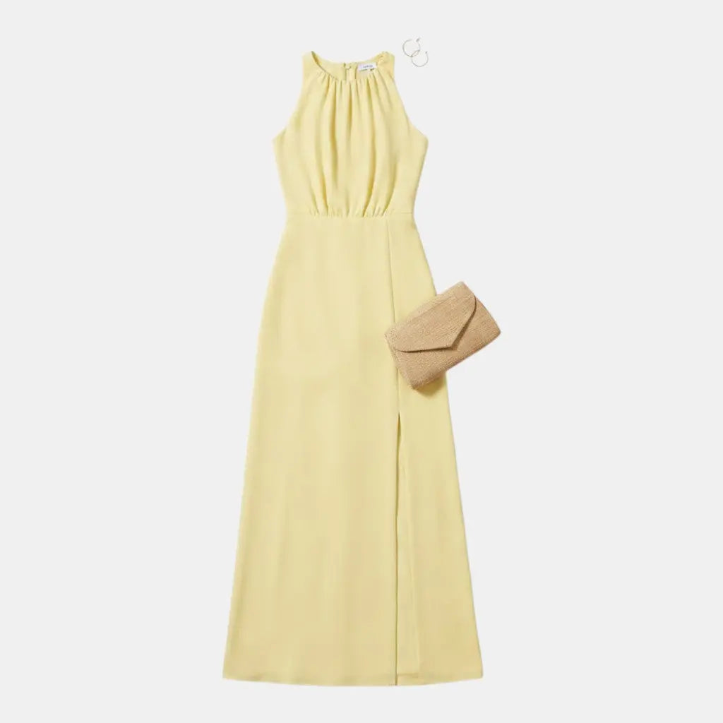 Panorla pale yellow sleeveless maxi dress with a high neckline and a thigh-high slit, made from light, breathable fabric.